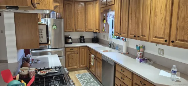 a kitchen with a sink stove and cabinets
