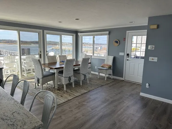 a view of a balcony with chairs and wooden floor