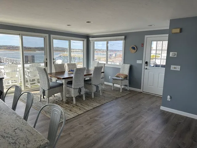 a view of a balcony with chairs and wooden floor