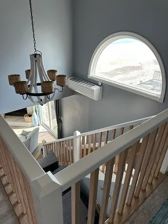 a bedroom with a bed and windows