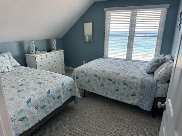 a spacious bedroom with a bed and large window