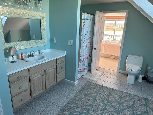 a bedroom with bed and glass door