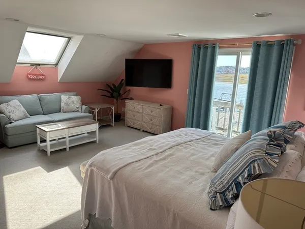 a bedroom with furniture and a flat screen tv