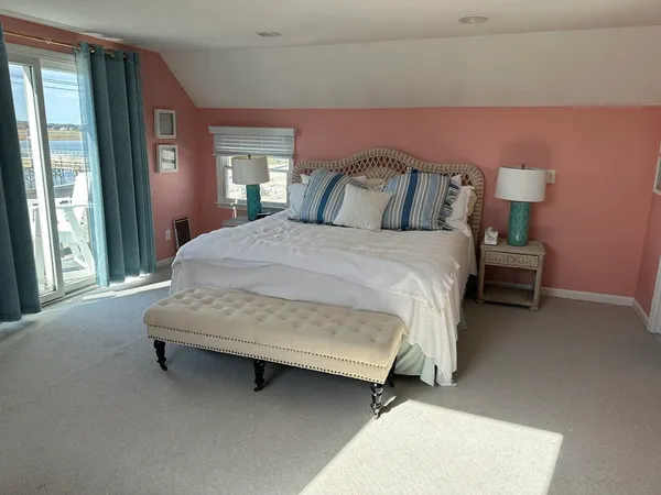 a view of a hallway with wooden floor and glass door