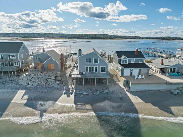 an aerial view of a house with a ocean view