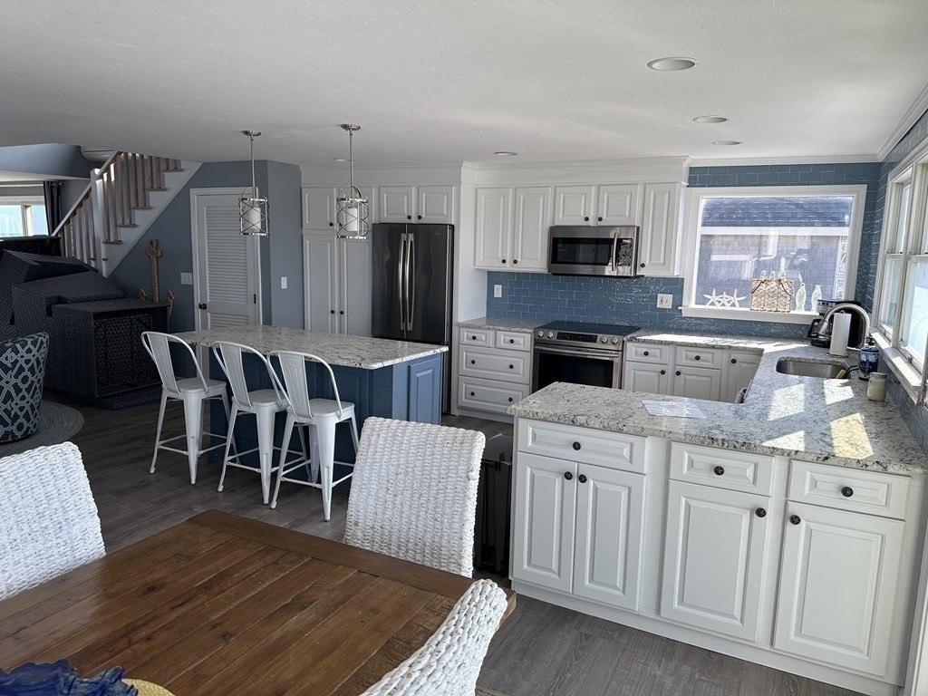230 Central Avenue Scituate, MA 02050 - Photo 8 of 34 a large kitchen with cabinets a sink a window and stainless steel appliances