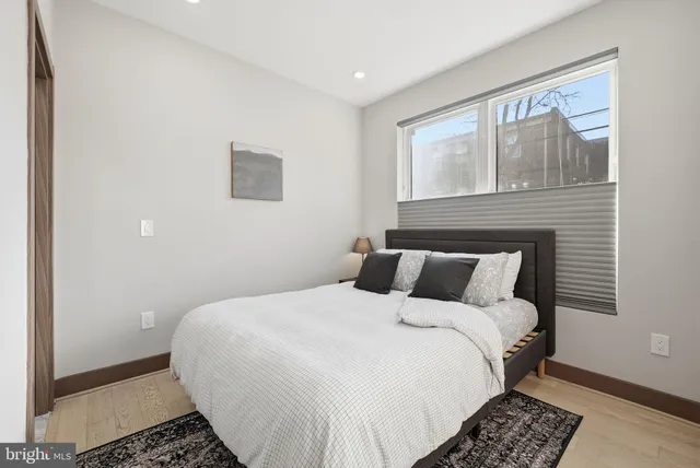 a bedroom with a bed and a window