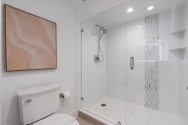 a bathroom with a shower and a toilet