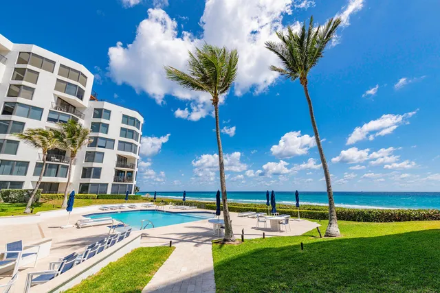 a view of a swimming pool with a yard