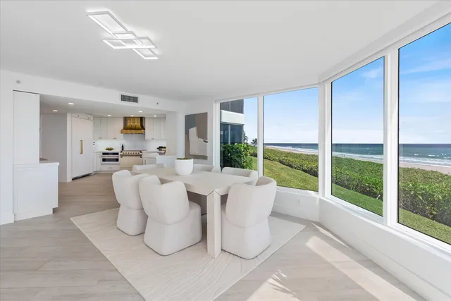 a living room with patio furniture and a large window