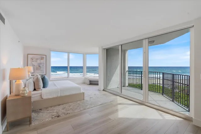 a bedroom with furniture and large window