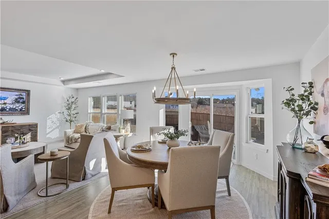 a view of a dining room with furniture wooden floor and chandelier
