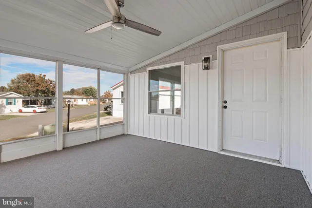 a view of an empty room with windows