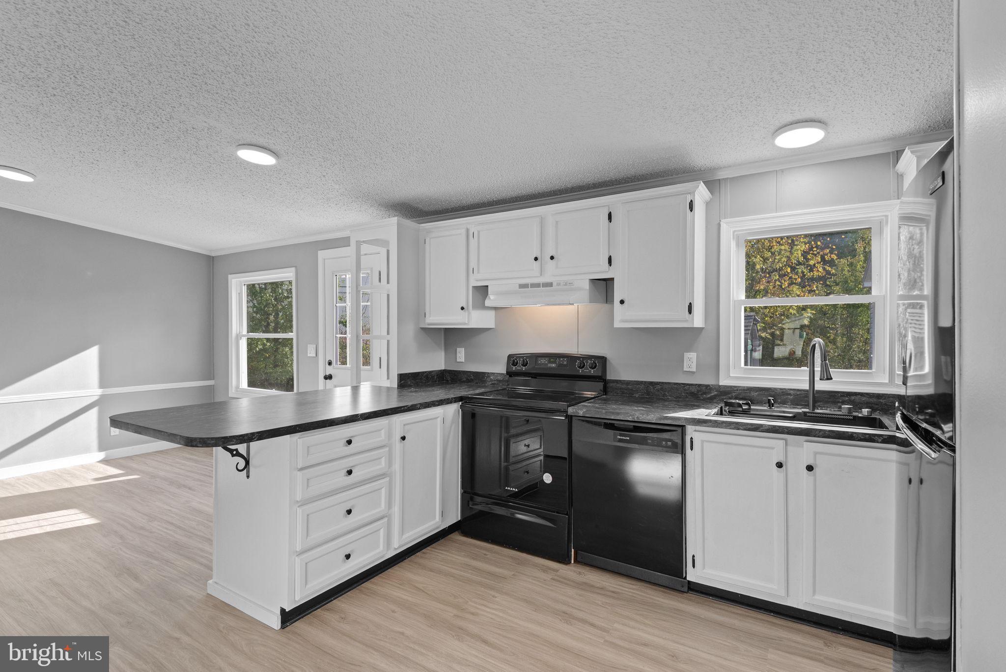 358 Pegram Street Gettysburg, PA 17325 - Photo 8 of 25 a kitchen with granite countertop white cabinets sink and stainless steel appliances