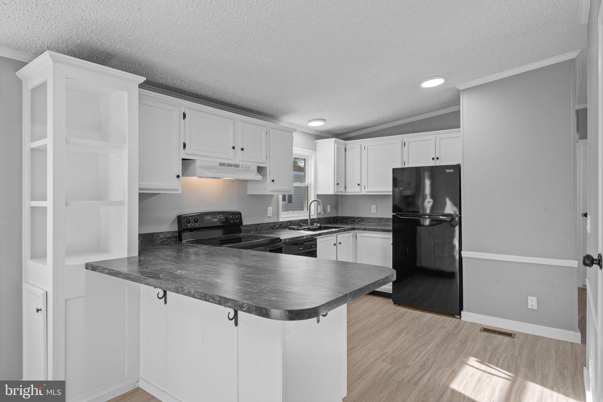 358 Pegram Street Gettysburg, PA 17325 - Photo 9 of 25 a kitchen with stainless steel appliances granite countertop a refrigerator a sink a stove a microwave and island