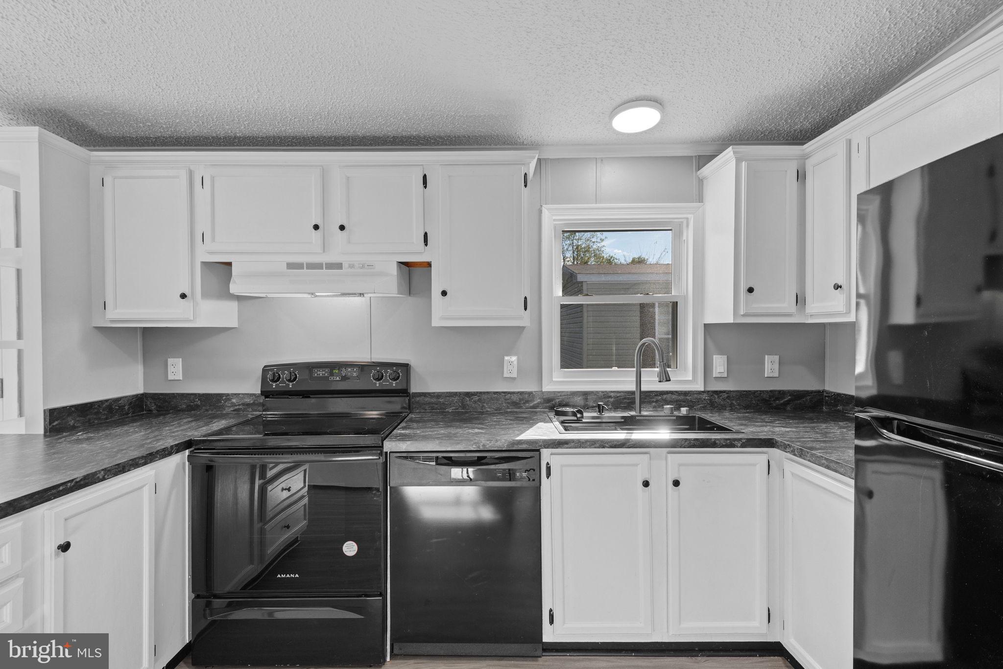 358 Pegram Street Gettysburg, PA 17325 - Photo 10 of 25 a kitchen with granite countertop a sink a stove and cabinets