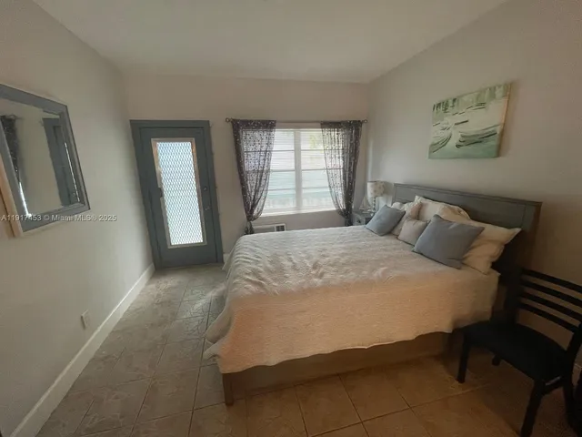 a bedroom with a bed and painting on the wall