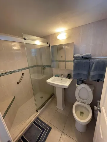 a bathroom with a sink toilet and shower