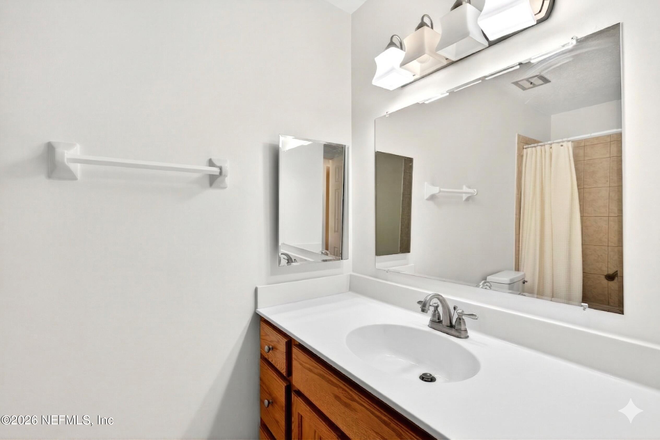 4358 Timuquana Road, Unit 150 Jacksonville, FL 32210 - Photo 12 of 21 a bathroom with a sink vanity and a mirror