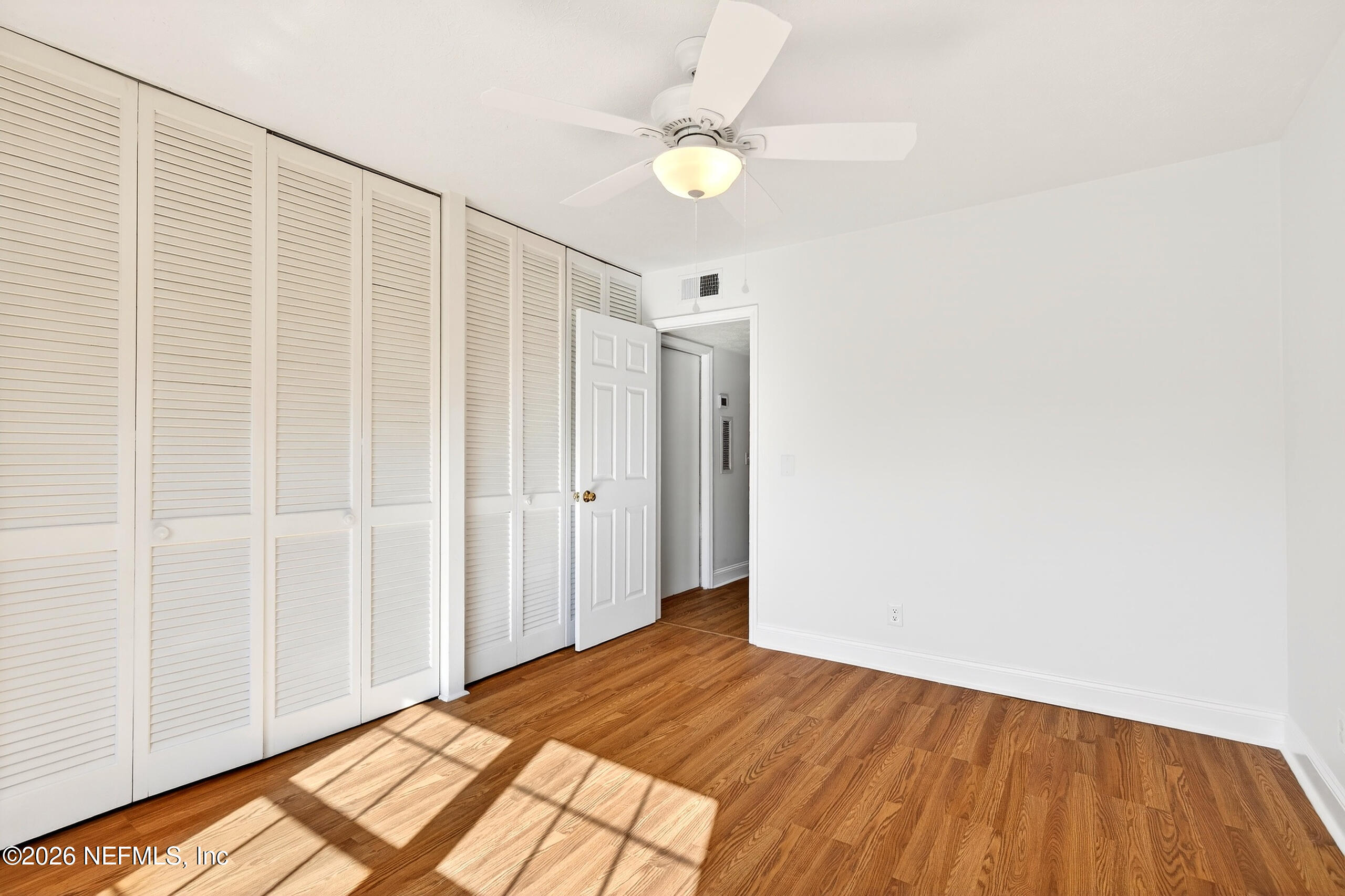 4358 Timuquana Road, Unit 150 Jacksonville, FL 32210 - Photo 14 of 21 a view of a room with wooden floor and a ceiling fan