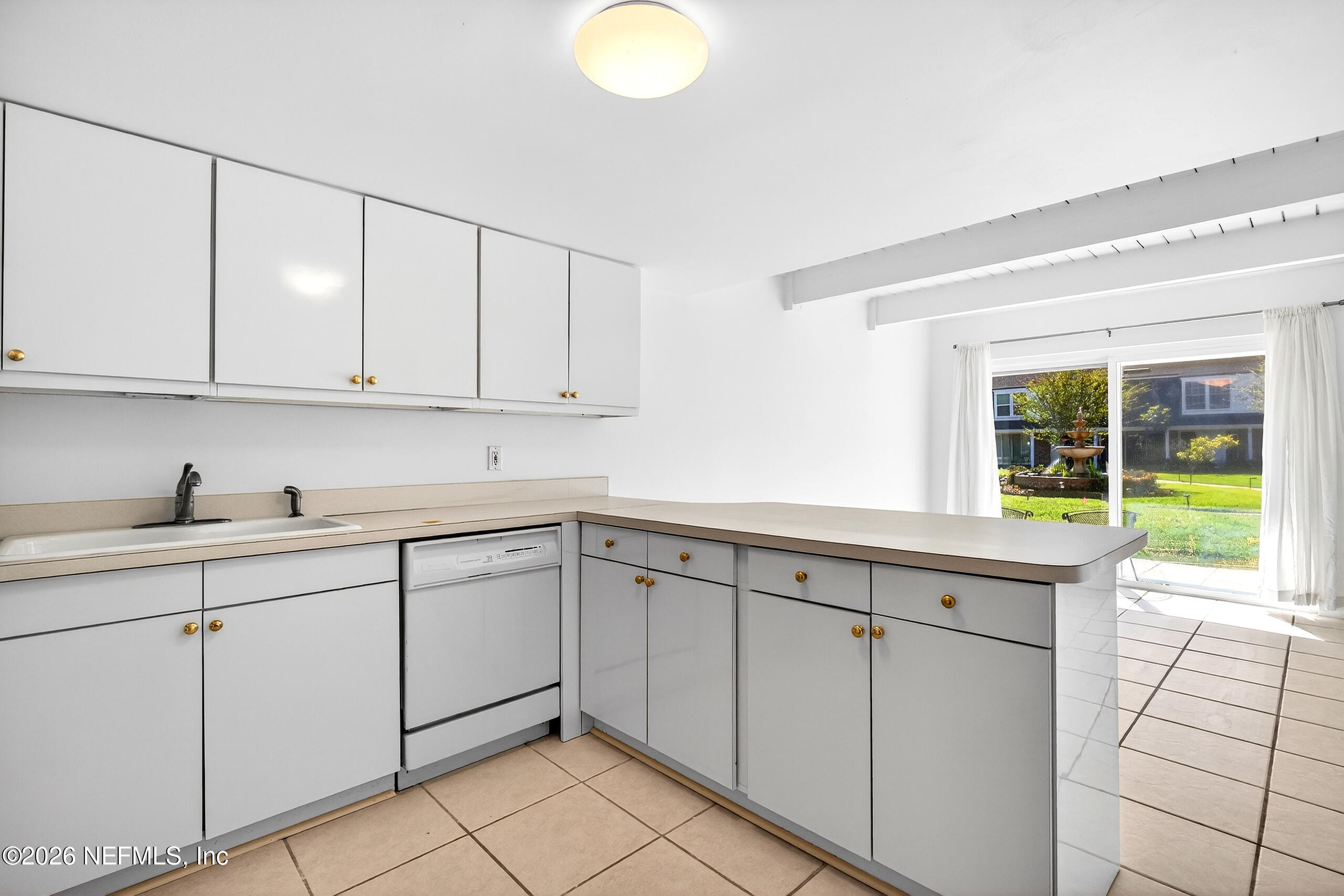 4358 Timuquana Road, Unit 150 Jacksonville, FL 32210 - Photo 5 of 21 a kitchen with granite countertop white cabinets and white appliances