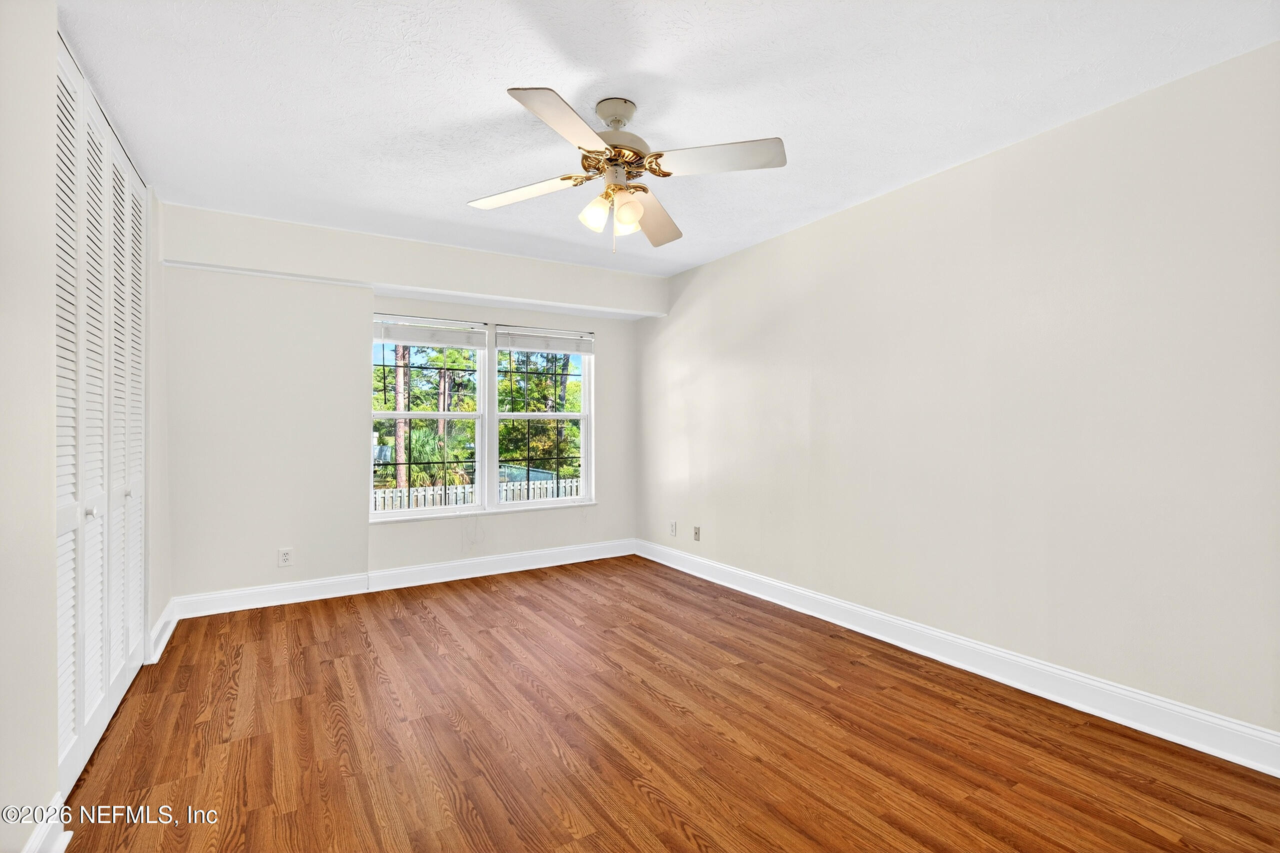 4358 Timuquana Road, Unit 150 Jacksonville, FL 32210 - Photo 10 of 21 wooden floor in an empty room with a window