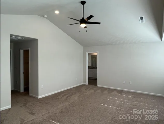 a view of an empty room with a ceiling fan