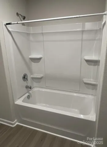 a bathroom with a shower and a bathtub