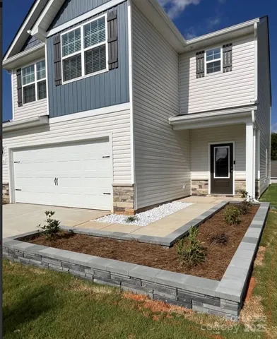 a front view of a house with garage