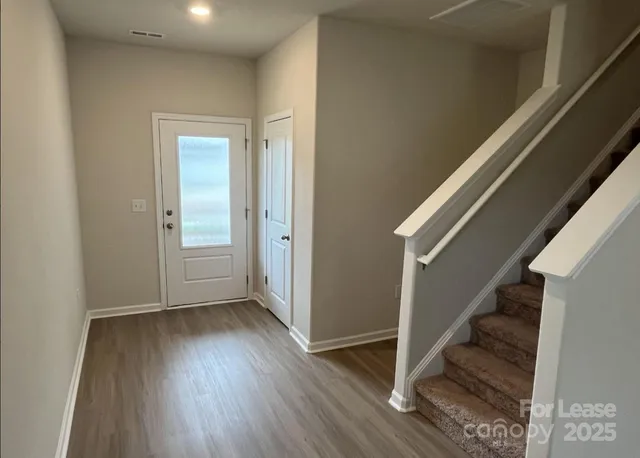 a view of an entryway with wooden floor