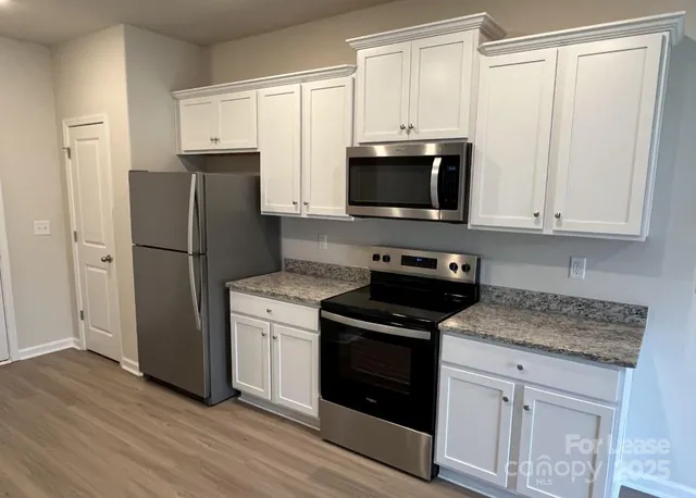 a kitchen with a refrigerator stove and microwave