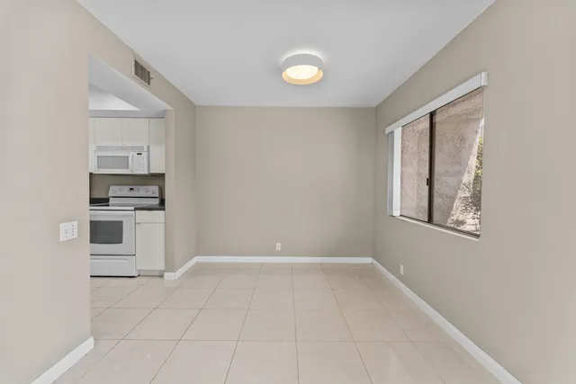 a view of kitchen with microwave and cabinets