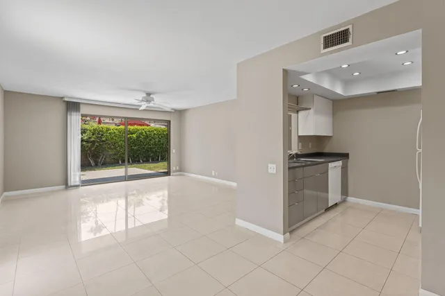 a view of kitchen with granite countertop cabinets and window