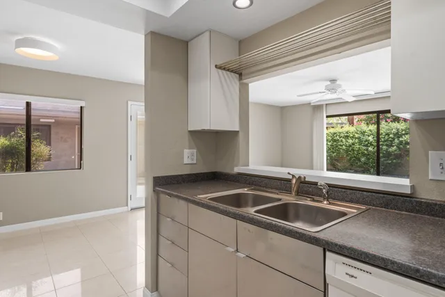 a kitchen with granite countertop a sink and a window