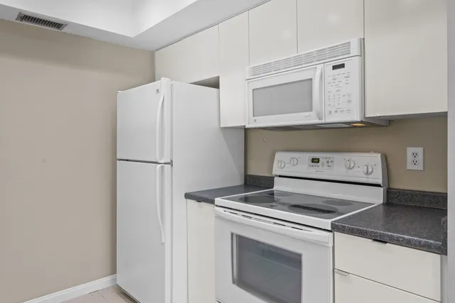 a kitchen with a stove and a refrigerator