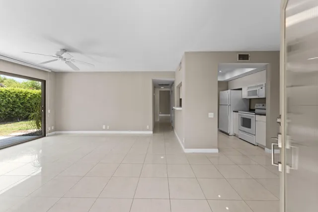 a view of a kitchen with a sink and a refrigerator