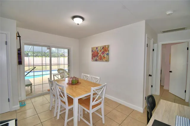 a dining room with furniture and window