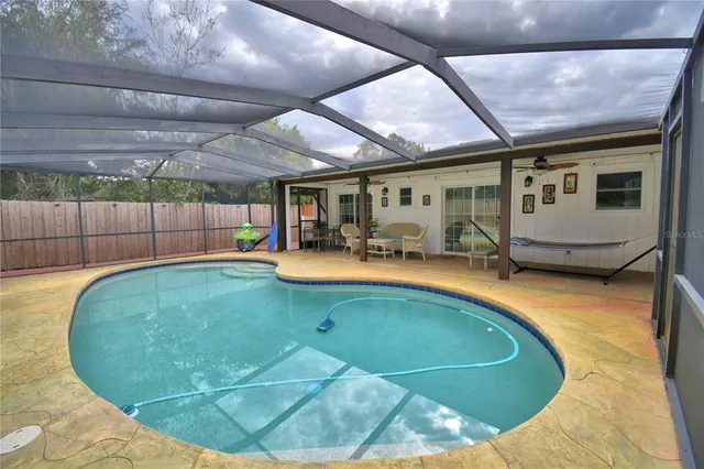 a view of a backyard with furniture and a backyard