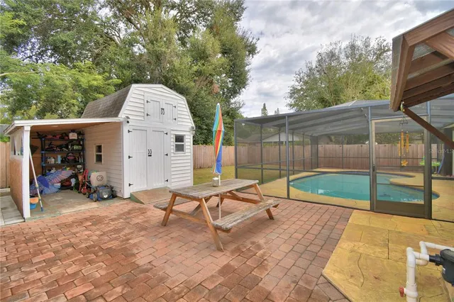 a view of a house with backyard and sitting area