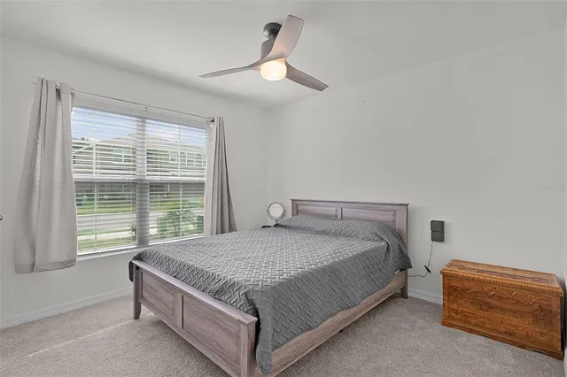 a bed sitting in a bedroom next to a window