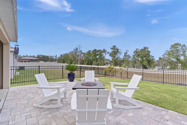 a view of a house with backyard and sitting area