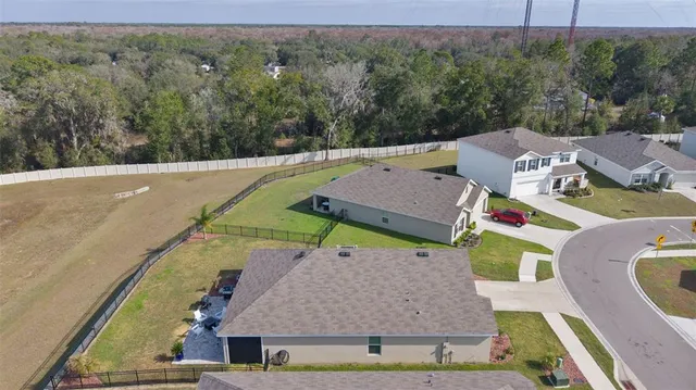 a view of a house with pool and a yard