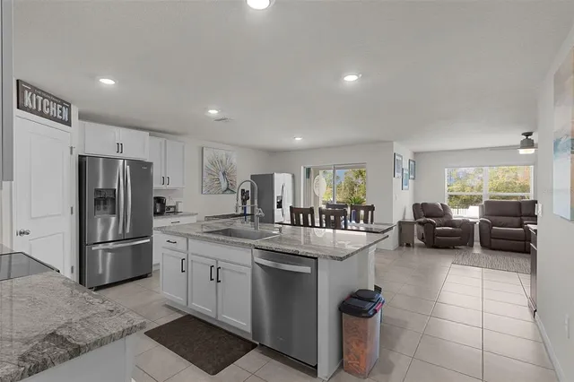 a kitchen with a refrigerator and a sink