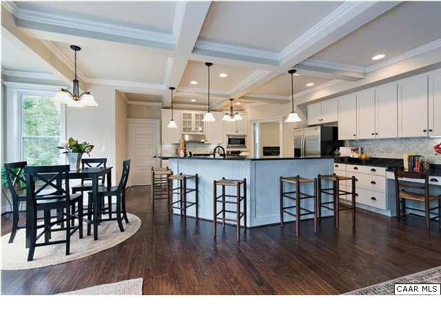 5309 Raven Stone Road Crozet, VA 22932 - Photo 15 of 38 a open kitchen with stainless steel appliances granite countertop a dining table chairs and granite counter tops