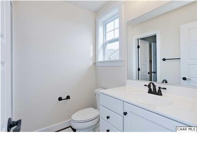 5309 Raven Stone Road Crozet, VA 22932 - Photo 29 of 38 a bathroom with a sink a toilet and mirror