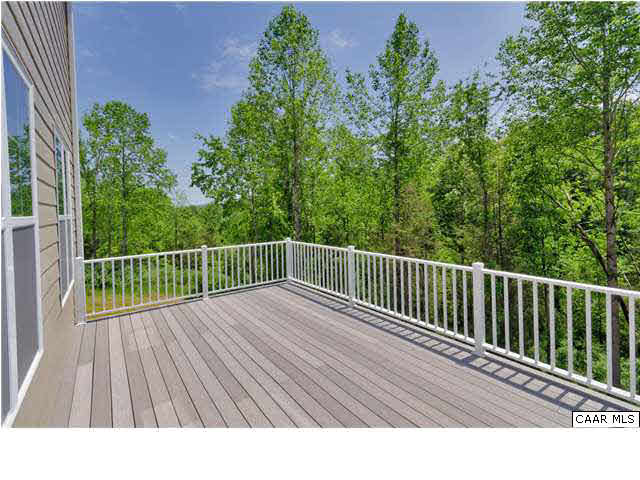 5309 Raven Stone Road Crozet, VA 22932 - Photo 36 of 38 a balcony with wooden floor and trees in the back