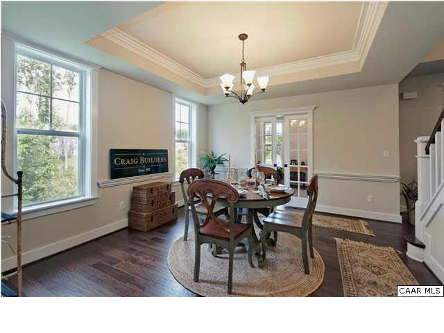 5309 Raven Stone Road Crozet, VA 22932 - Photo 8 of 38 a living room with furniture dining table a fireplace and a large window