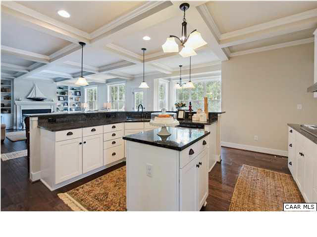 5309 Raven Stone Road Crozet, VA 22932 - Photo 10 of 38 a kitchen with granite countertop a sink stainless steel appliances white cabinets and a chandelier