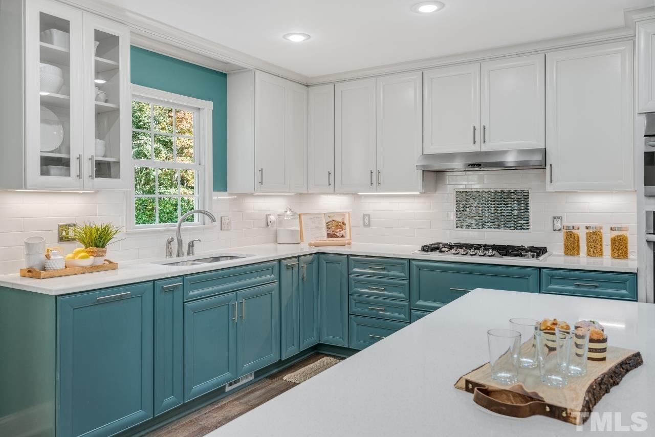 4108 Pleasant Grove Church Road Raleigh, NC 27613 - Photo 2 of 30 a kitchen with stainless steel appliances granite countertop a sink and cabinets