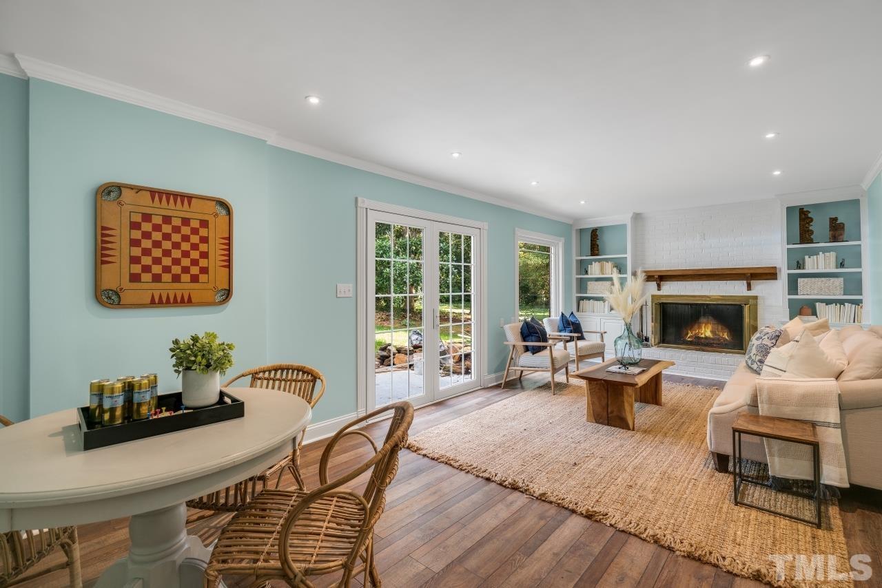 4108 Pleasant Grove Church Road Raleigh, NC 27613 - Photo 11 of 30 a living room with furniture a fireplace and a large window